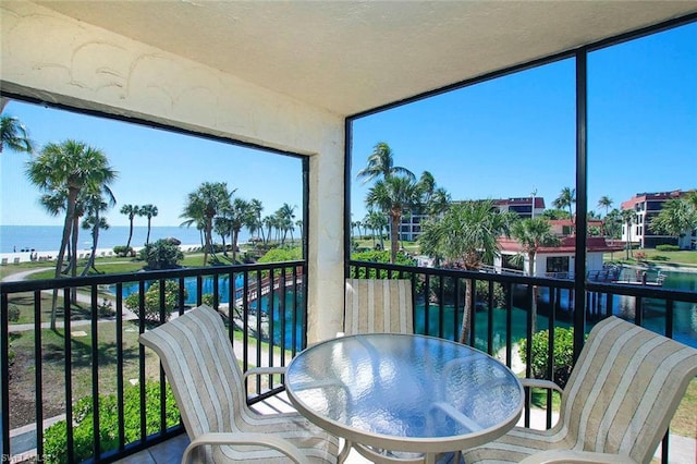 sunroom / solarium with a water view