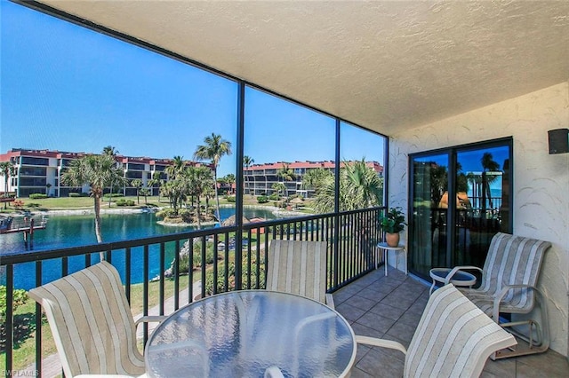 sunroom / solarium with a water view