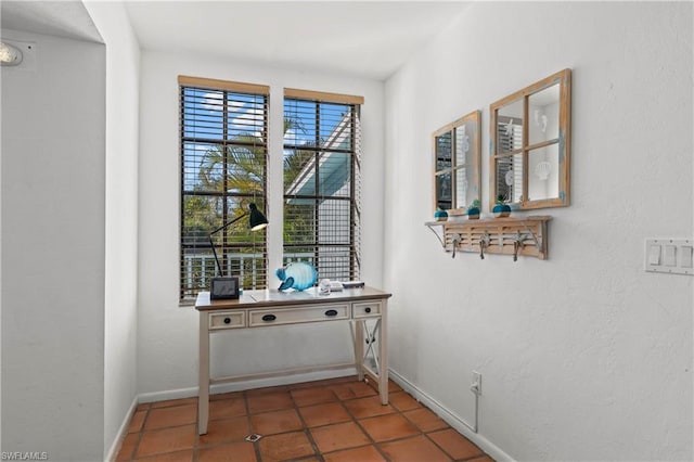 entryway featuring dark tile flooring