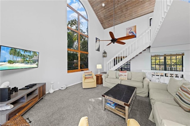 carpeted living room with high vaulted ceiling, ceiling fan, and wooden ceiling