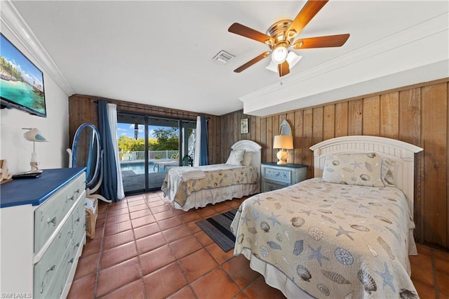 bedroom featuring wooden walls, ceiling fan, access to outside, and dark tile floors