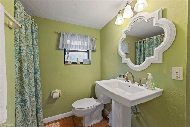 bathroom with toilet, tile flooring, and a notable chandelier