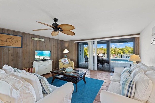 tiled living room with wood walls and ceiling fan