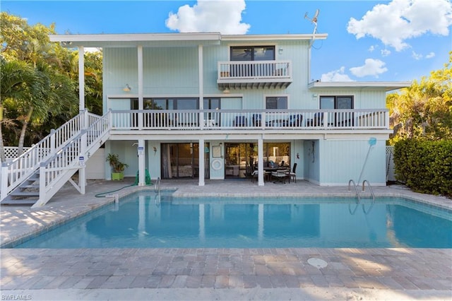 back of house featuring a balcony and a patio area