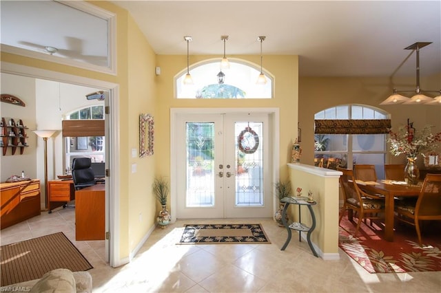 tiled foyer with french doors and a high ceiling