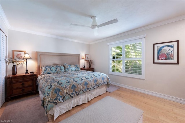 bedroom featuring light hardwood / wood-style flooring, ornamental molding, and ceiling fan