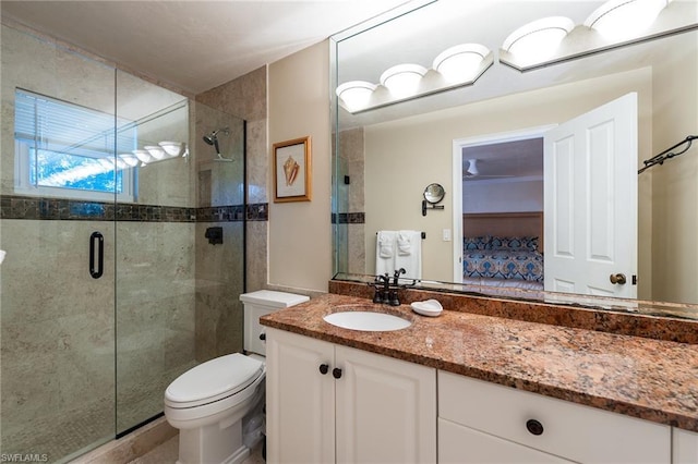 bathroom with an enclosed shower, oversized vanity, and toilet