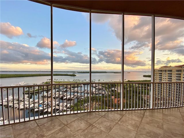 unfurnished sunroom with a water view