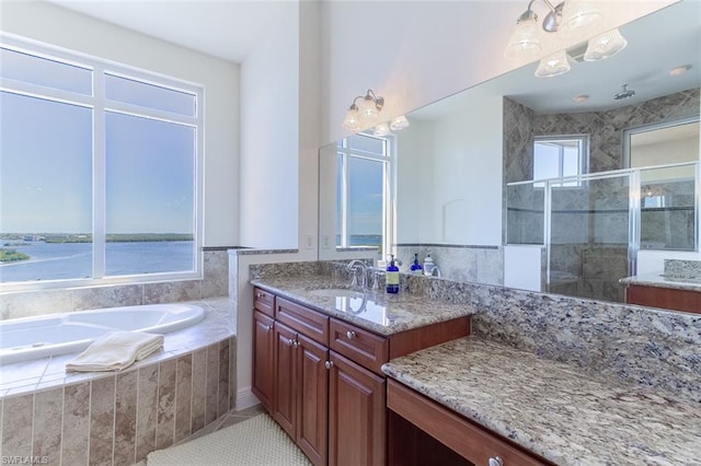 bathroom with tiled bath, tile floors, and vanity