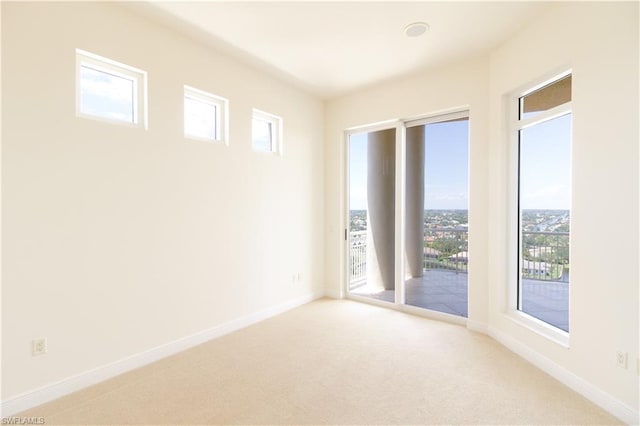 unfurnished room featuring light colored carpet