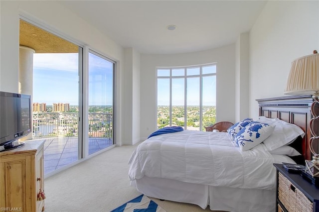 bedroom featuring light colored carpet and access to outside