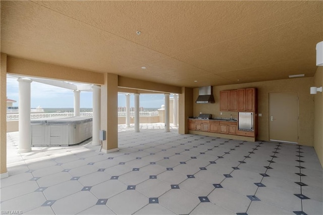 unfurnished living room with light tile floors and a textured ceiling