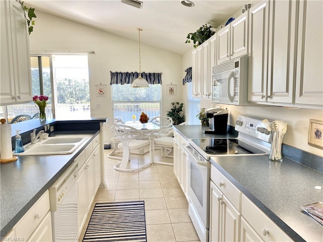 kitchen with plenty of natural light, white appliances, and white cabinetry