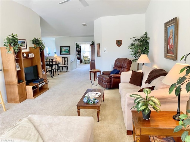 living room with light carpet, lofted ceiling, and ceiling fan