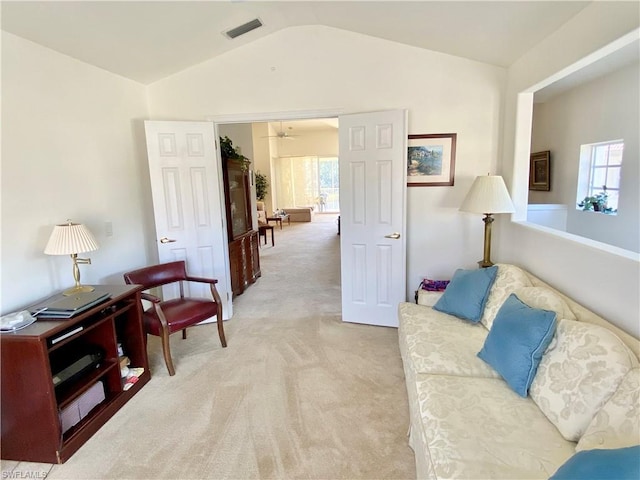 living room featuring light colored carpet, a healthy amount of sunlight, vaulted ceiling, and ceiling fan