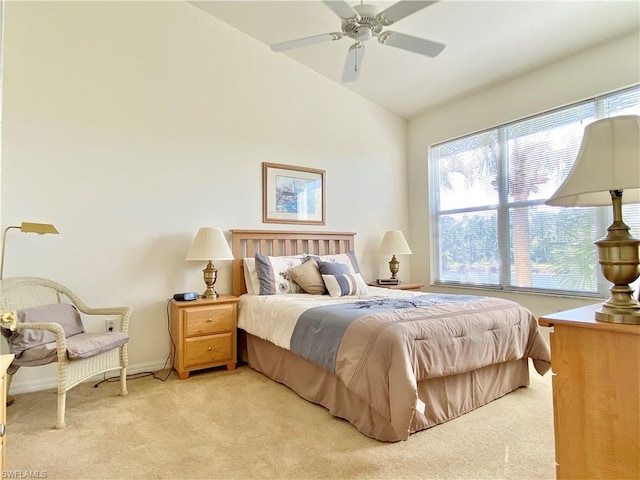 bedroom featuring light carpet, vaulted ceiling, and ceiling fan