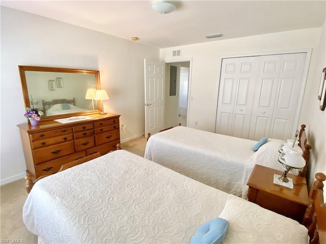 bedroom with a closet and light carpet