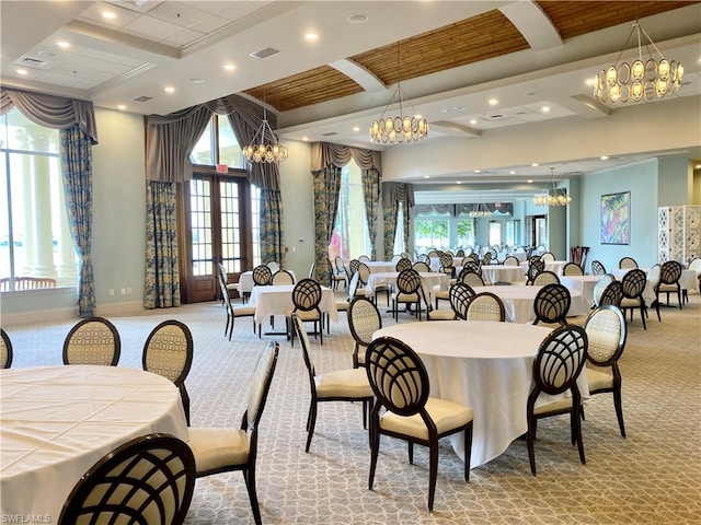 dining space with light carpet, plenty of natural light, and a notable chandelier