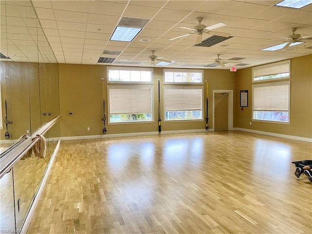 interior space featuring ceiling fan, a drop ceiling, and light wood-type flooring