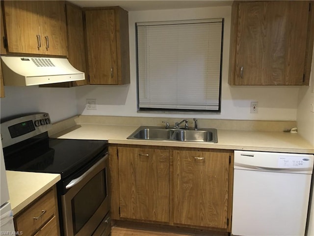 kitchen featuring white dishwasher, custom range hood, sink, and stainless steel electric stove