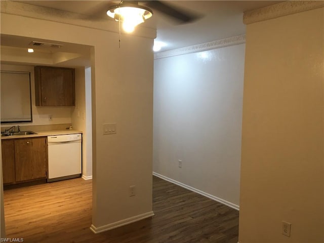 kitchen featuring wood-type flooring, ceiling fan, dishwasher, and sink