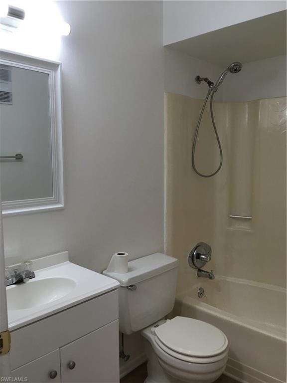 full bathroom featuring shower / bathing tub combination, toilet, and vanity with extensive cabinet space