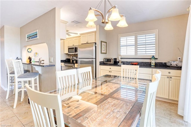 dining area featuring a chandelier and light tile flooring