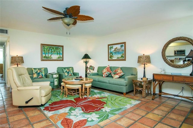 tiled living room featuring ceiling fan