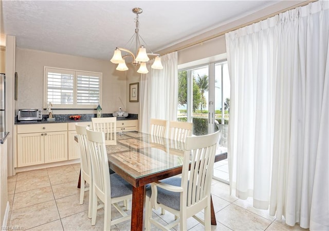 tiled dining room with plenty of natural light and a notable chandelier