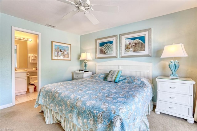 bedroom with connected bathroom, ceiling fan, and light colored carpet