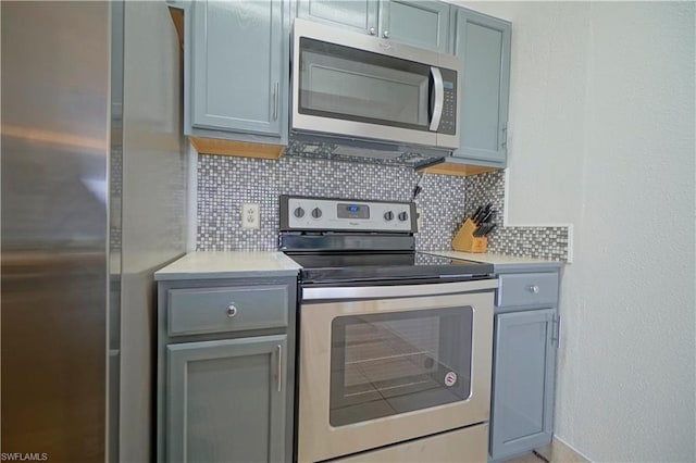 kitchen with appliances with stainless steel finishes and tasteful backsplash