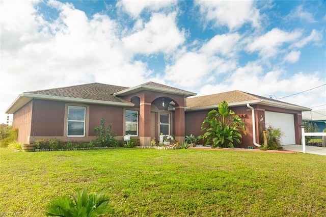 view of front facade with a front yard and a garage