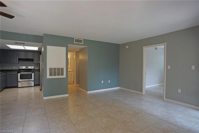 tiled empty room featuring ceiling fan