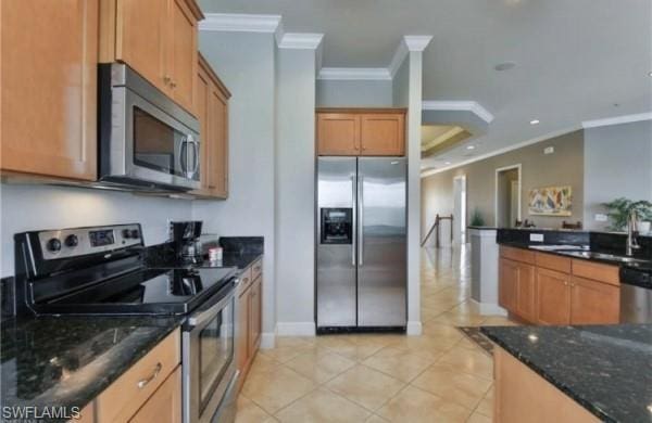 kitchen with light tile flooring, stainless steel appliances, dark stone countertops, and crown molding