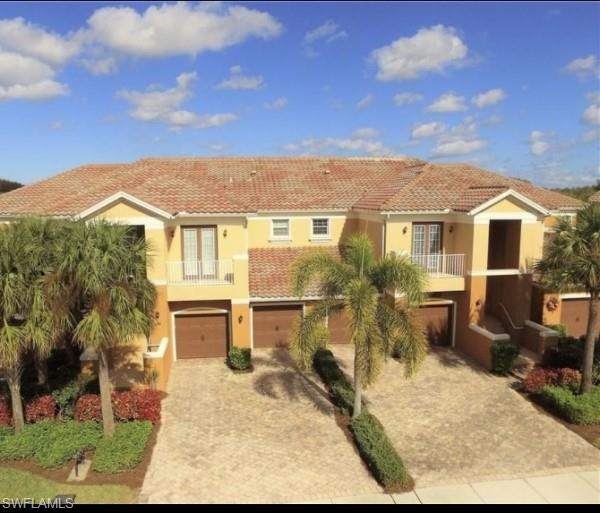 mediterranean / spanish-style home featuring a balcony and a garage