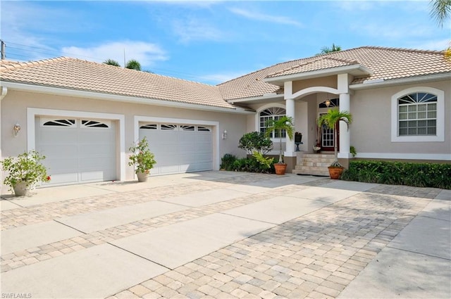 mediterranean / spanish-style home with a garage