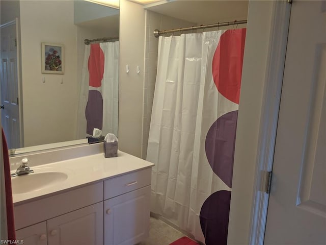 bathroom featuring vanity with extensive cabinet space and tile flooring