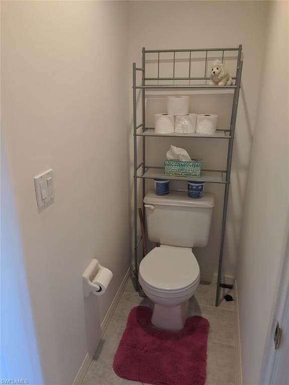 bathroom with toilet and tile floors