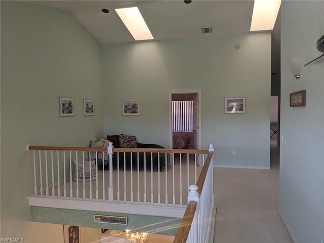 interior space with high vaulted ceiling, an inviting chandelier, and a skylight