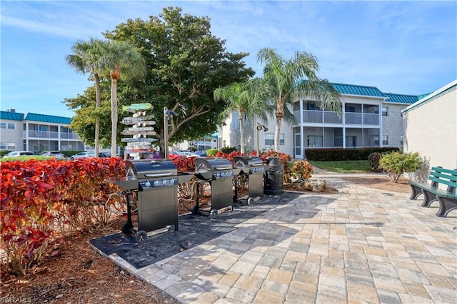 view of patio with a balcony and area for grilling