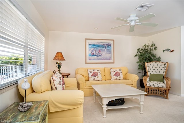 living room featuring light colored carpet and ceiling fan