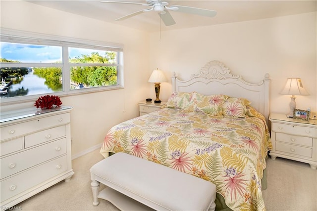 bedroom featuring light carpet and ceiling fan