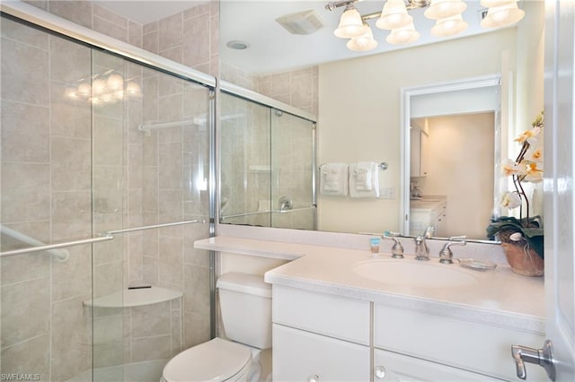 bathroom with an enclosed shower, toilet, and vanity