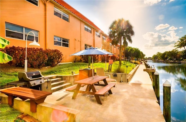 exterior space featuring a water view and a patio area