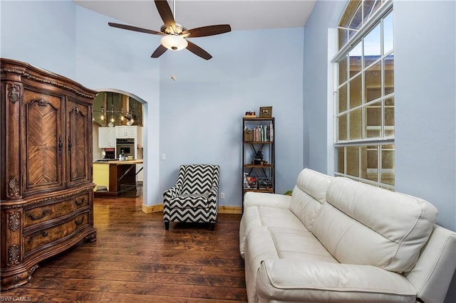 living room with high vaulted ceiling, dark hardwood / wood-style flooring, and ceiling fan