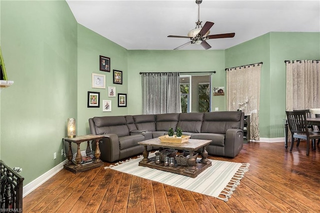 living room featuring ceiling fan and dark wood-type flooring