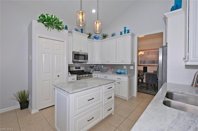 kitchen with light tile floors, appliances with stainless steel finishes, tasteful backsplash, and sink