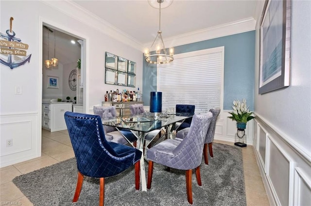 dining space with crown molding, light tile flooring, and a chandelier