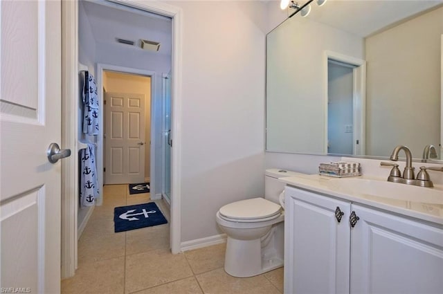 bathroom featuring toilet, tile floors, and oversized vanity