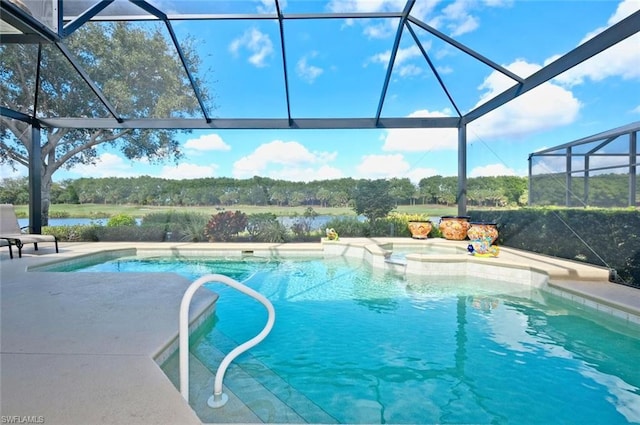 view of swimming pool featuring a patio area and a lanai